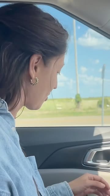 Rachel Koulianos looking out a car window at open country