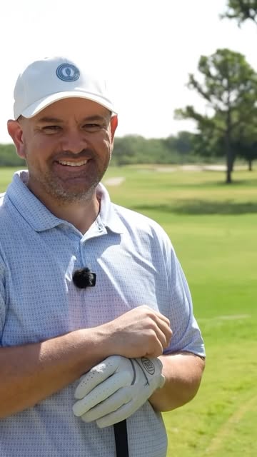 A smiling man on the golf course for a Tee-ology conversation